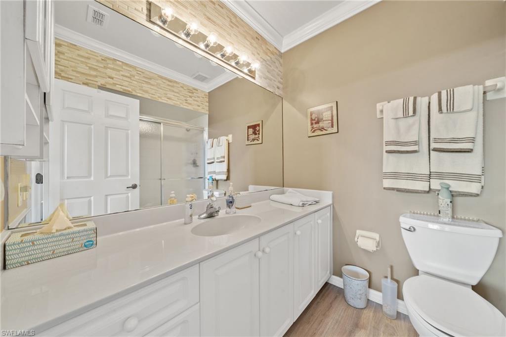 14771 Hole In 1 Circle, Unit 108 Fort Myers, FL 33919 - Photo 16 of 22 a bathroom with a toilet a sink and mirror