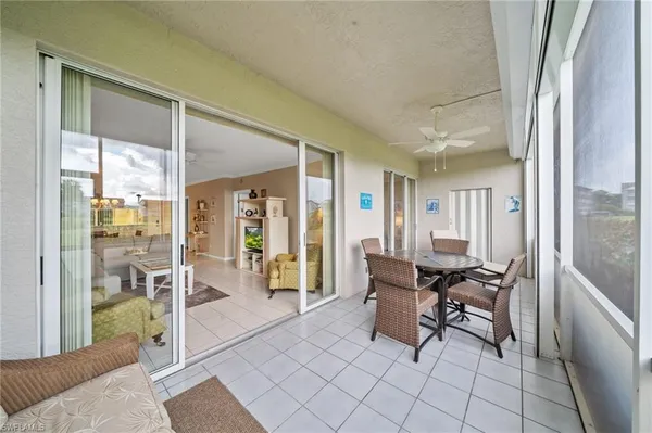 a dining room with furniture and floor to ceiling window