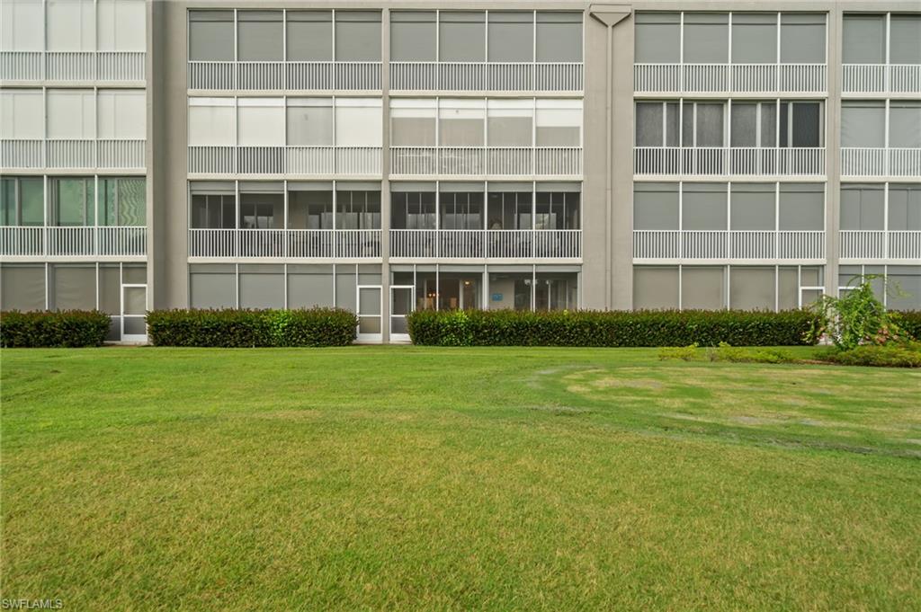 14771 Hole In 1 Circle, Unit 108 Fort Myers, FL 33919 - Photo 20 of 22 a front view of a house with a yard