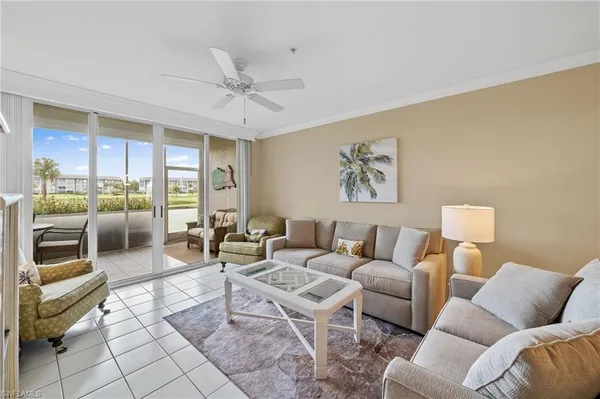 a living room with furniture and a floor to ceiling window
