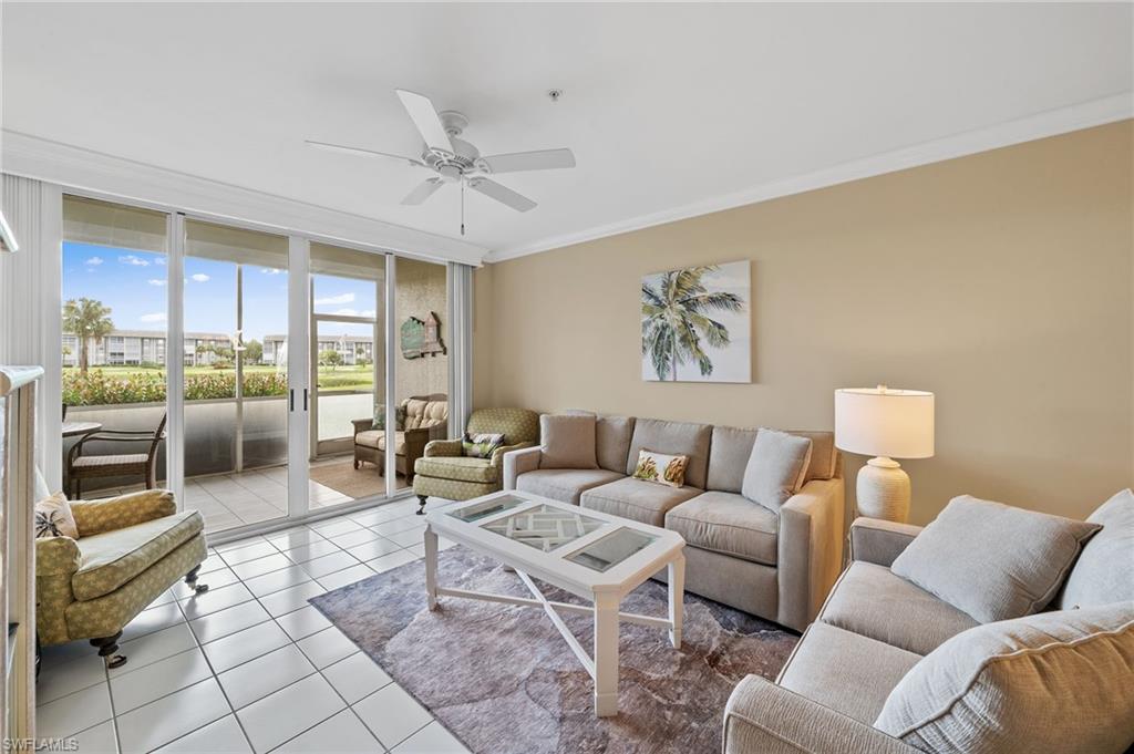 14771 Hole In 1 Circle, Unit 108 Fort Myers, FL 33919 - Photo 6 of 22 a living room with furniture and a floor to ceiling window