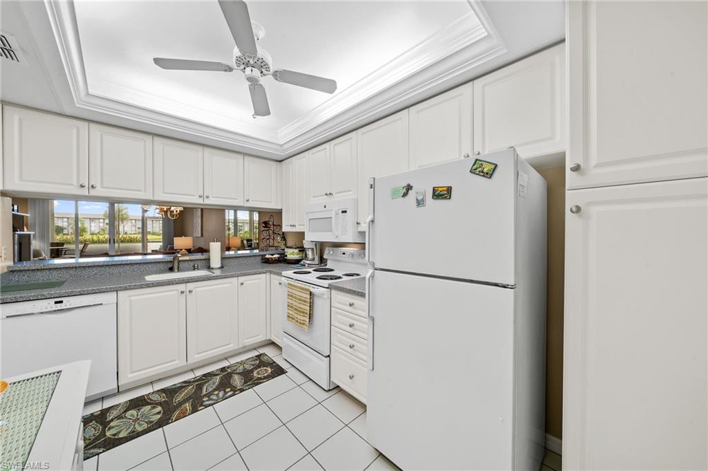 14771 Hole In 1 Circle, Unit 108 Fort Myers, FL 33919 - Photo 10 of 22 a white refrigerator freezer sitting inside of a kitchen