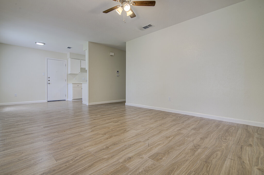5301 Indio Circle, Unit A Austin, TX 78745 - Photo 5 of 25 Natural light illuminates the open-concept living space with durable wood-look flooring.