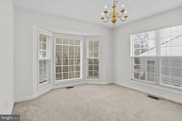 a view of an empty room with a kitchen