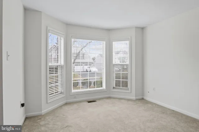 a view of a hallway with wooden floor and stairs