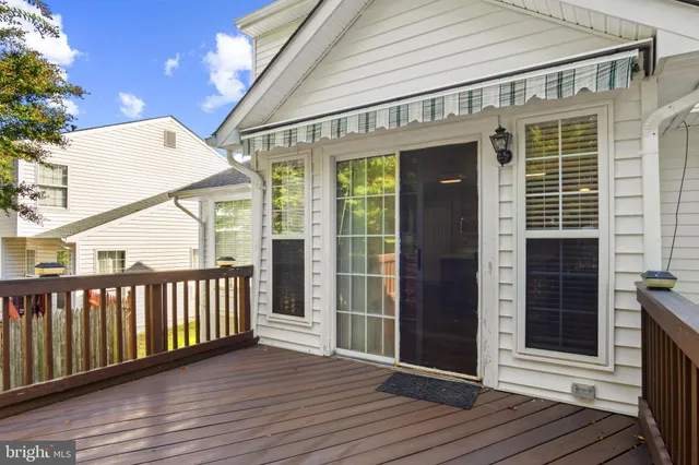 a view of a house with a yard balcony and sitting area