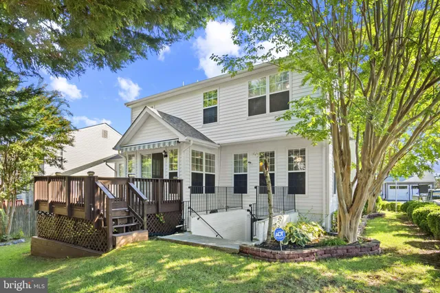 a kitchen with a sink a stove a refrigerator and white cabinets