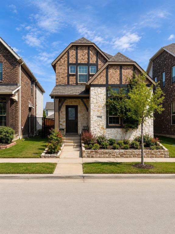 Two-story exterior featuring a stone and brick facade with decorative timber accents