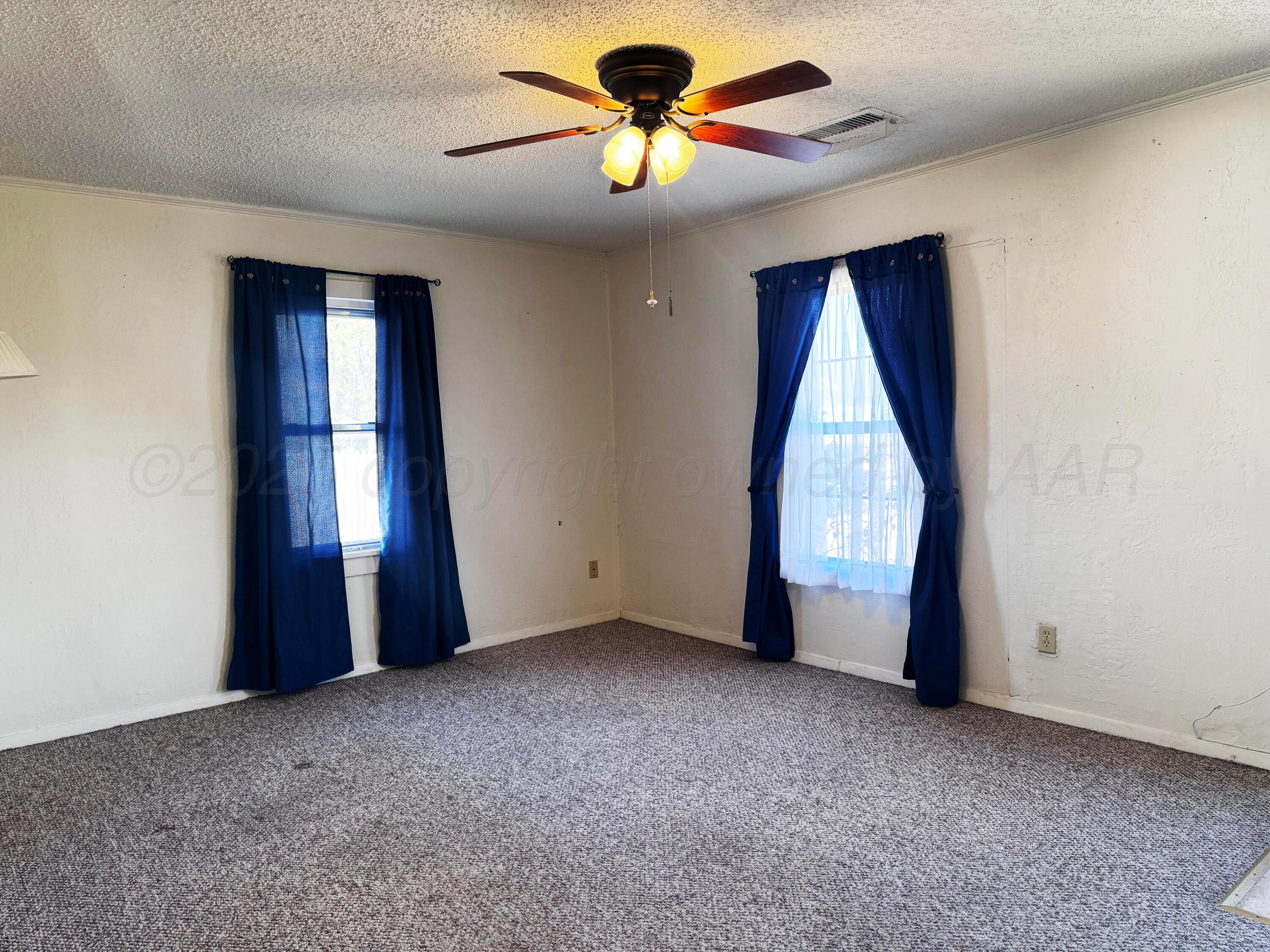 4004 South Hayden Street Amarillo, TX 79110 - Photo 4 of 14 a view of an empty room with a window