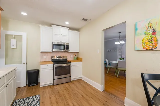 a kitchen with stainless steel appliances granite countertop a stove and a refrigerator