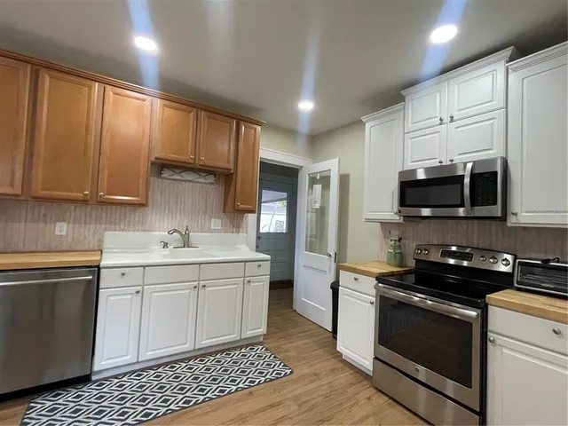 a kitchen with stainless steel appliances a sink stove and refrigerator