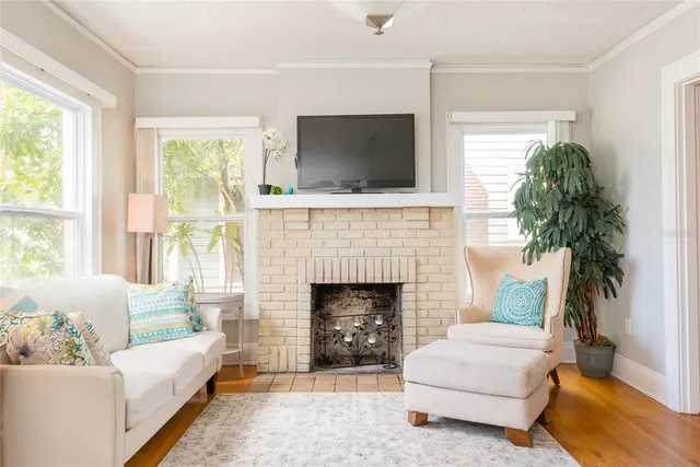 a living room with furniture a flat screen tv and a fireplace
