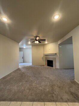 3205 112th Street Lubbock, TX 79423 - Photo 7 of 19 an empty room with windows and fireplace
