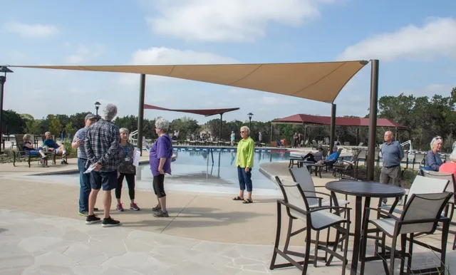 a view of a swimming pool and a yard