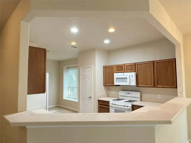 a kitchen with a sink cabinets and appliances