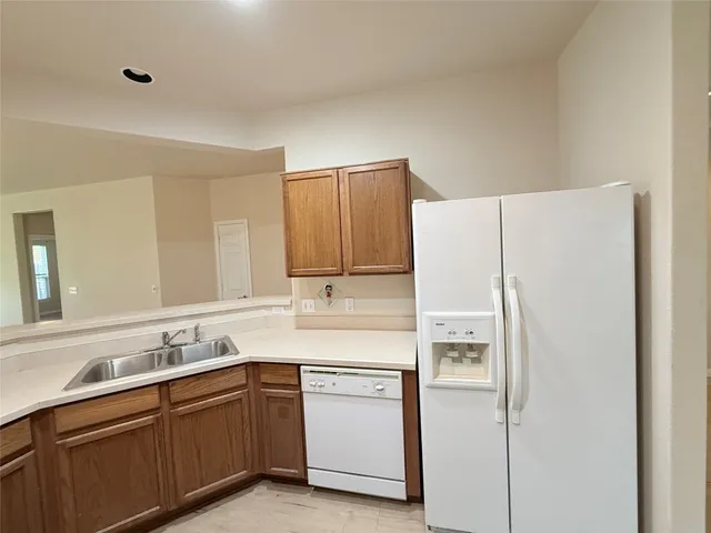 a kitchen with a white cabinets and refrigerator