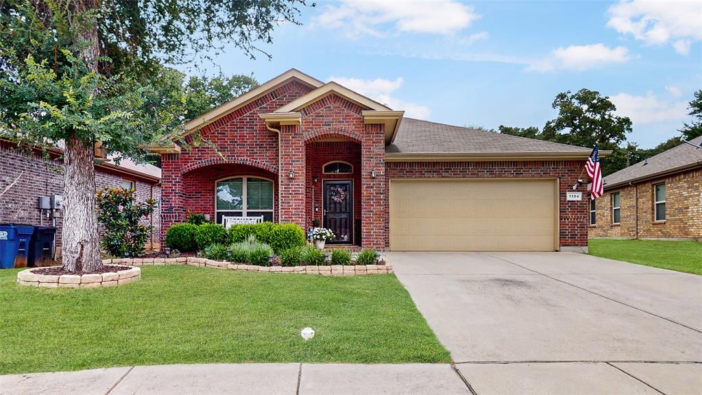 1104 Edgewater Drive Azle, TX 76020 - Photo 1 of 1 a front view of a house with a yard and garage