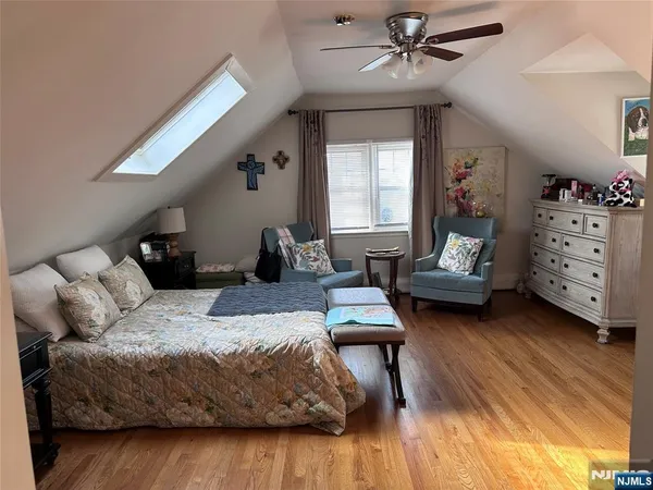 a bedroom with furniture and a wooden floor