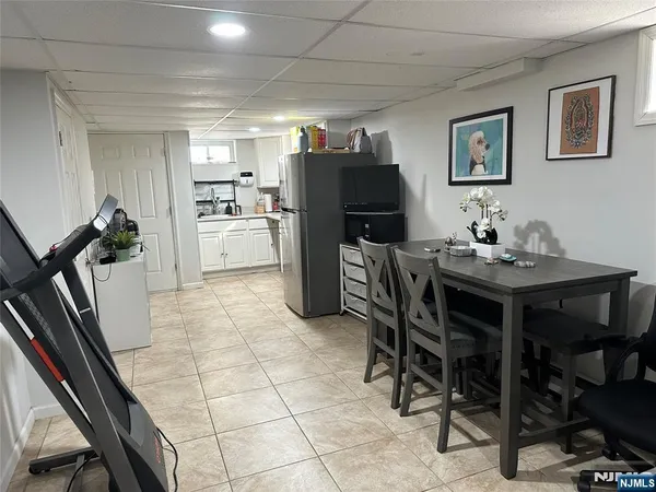 a kitchen with a table chairs and a refrigerator