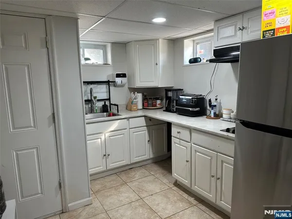 a kitchen with a sink cabinets and stainless steel appliances