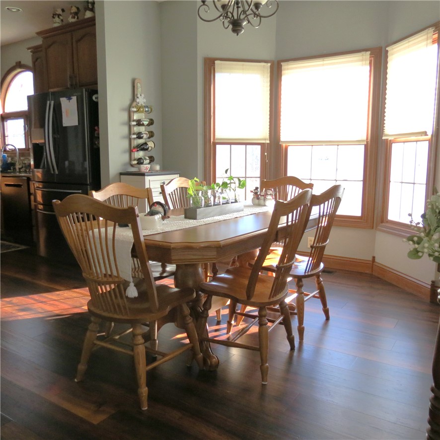 10160 Lochard Road Sidney, OH 45365 - Photo 13 of 41 This inviting dining area features ample natural light and seamless access to the adjacent kitchen.