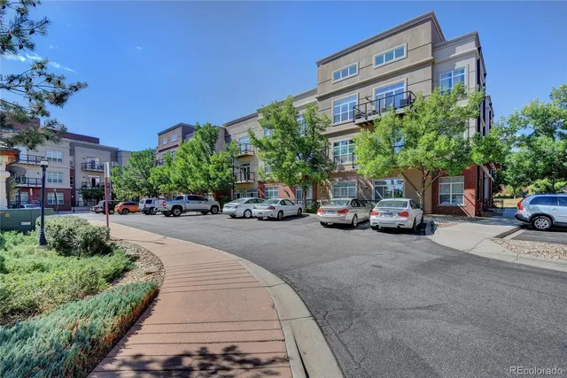 a couple of cars parked in front of a building
