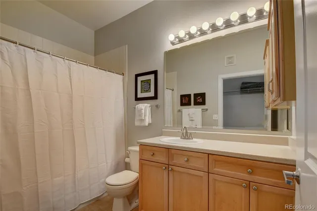 a bathroom with a toilet a sink and a mirror