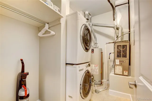 a utility room with dryer washer and a view of bathroom