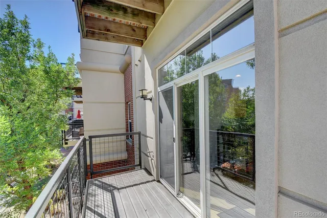 a view of balcony with wooden floor and garden