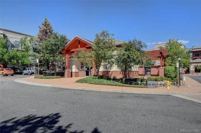 a street sign on a sidewalk next to a building