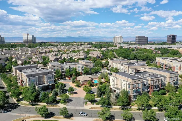 an aerial view of residential houses with city view