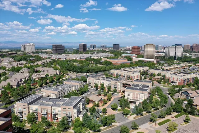 an aerial view of residential houses with city view