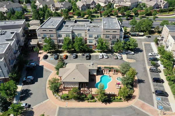 an aerial view of a house with a yard and lake view