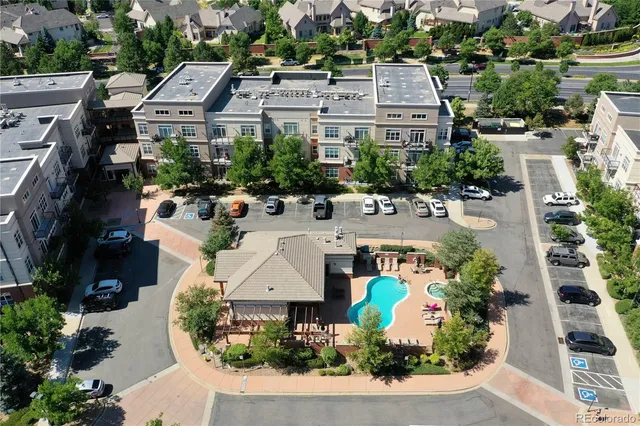 an aerial view of a house with a yard and lake view