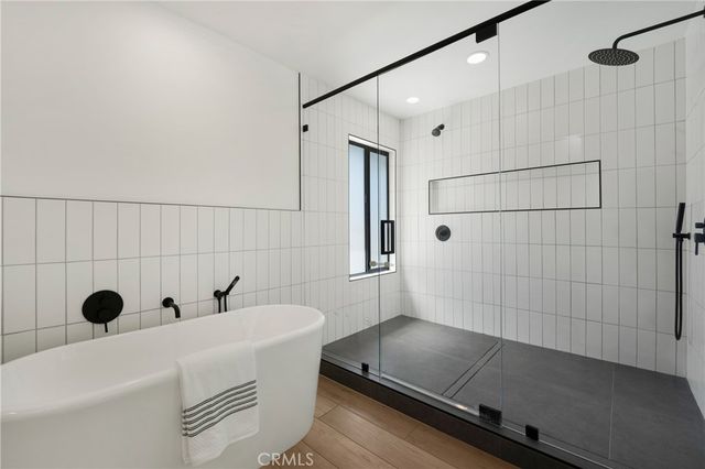 a bathroom with a tub and a shower