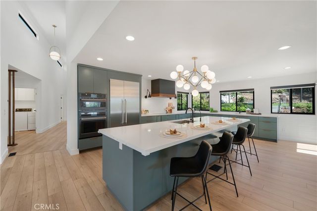 a large kitchen with a table and chairs