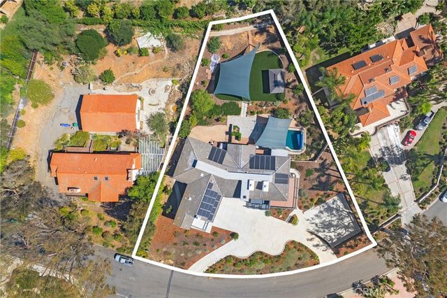 an aerial view of house with a yard