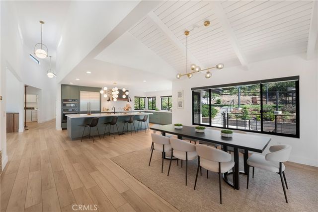 a large kitchen with a table and chairs