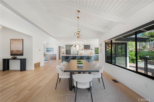 a view of a dining room with furniture large window and wooden floor
