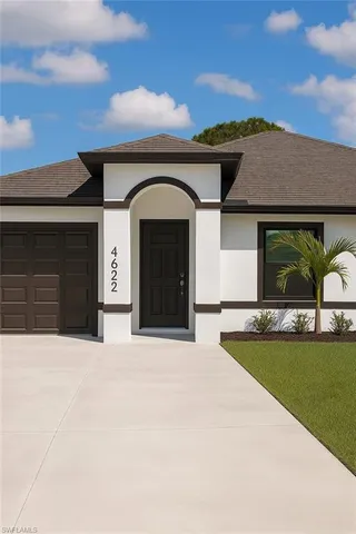 a front view of a house with a garden