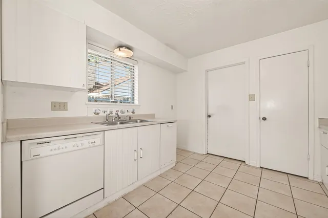 a bathroom with a granite countertop sink mirror and shower