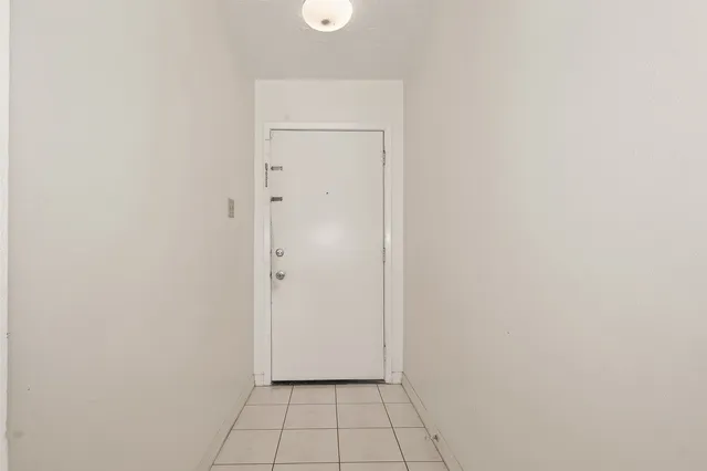 a view of an empty room with glass door