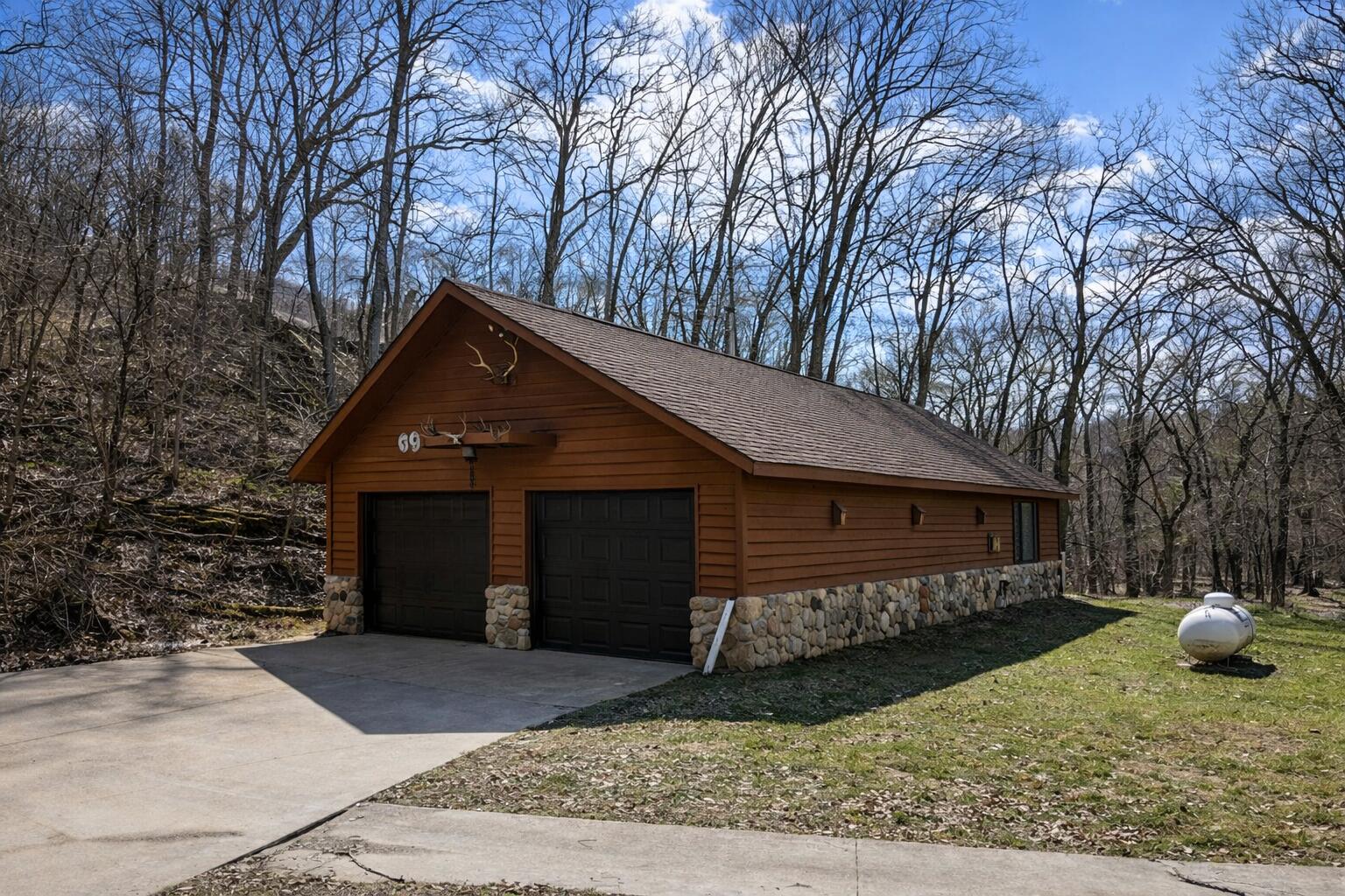 57751 Rainbow Drive Freeman, WI 54628 - Photo 21 of 32 Wooded garage with deer antlers