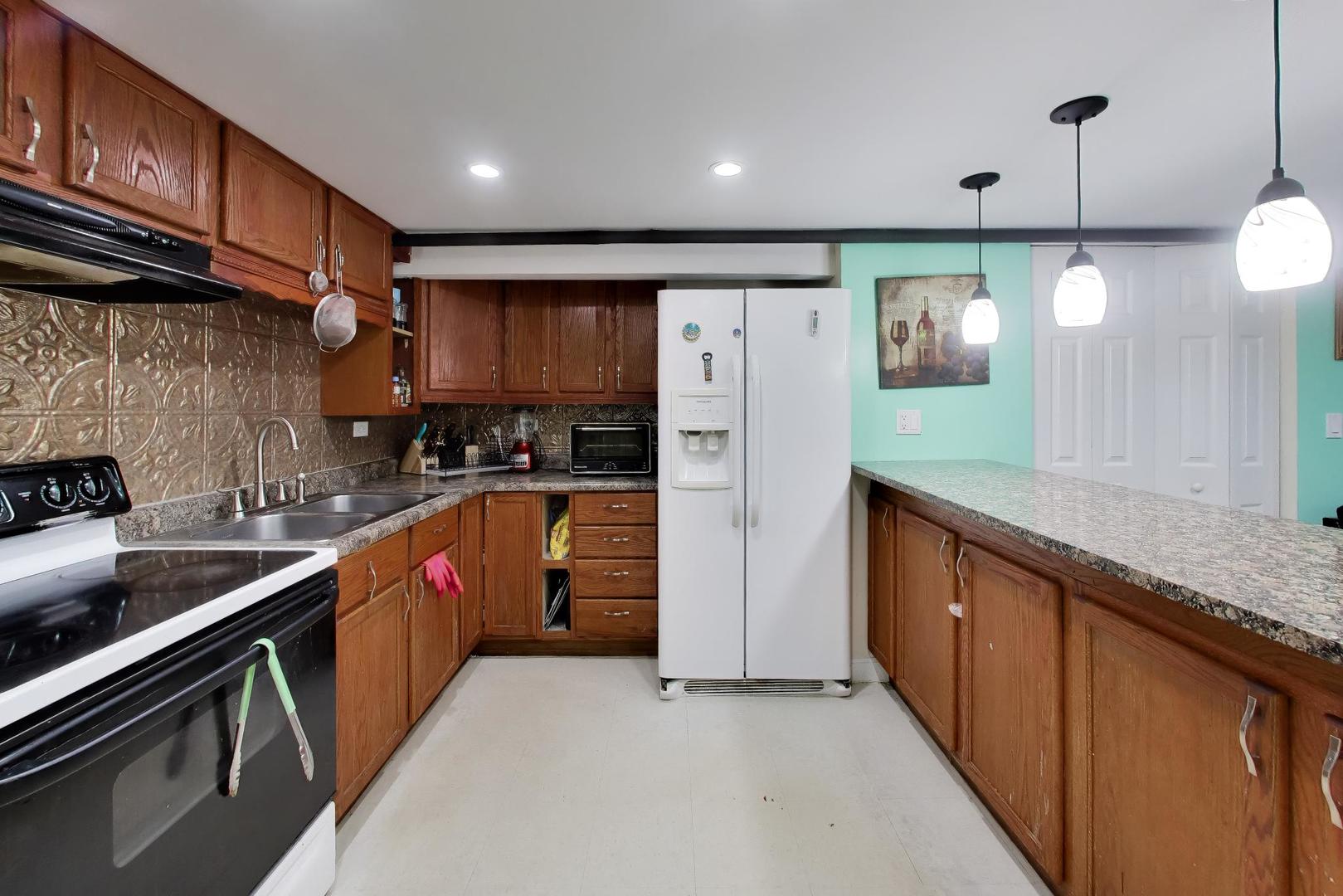 458 West Alma Street Elmhurst, IL 60126 - Photo 19 of 29 a kitchen with stainless steel appliances granite countertop a refrigerator a sink and a stove