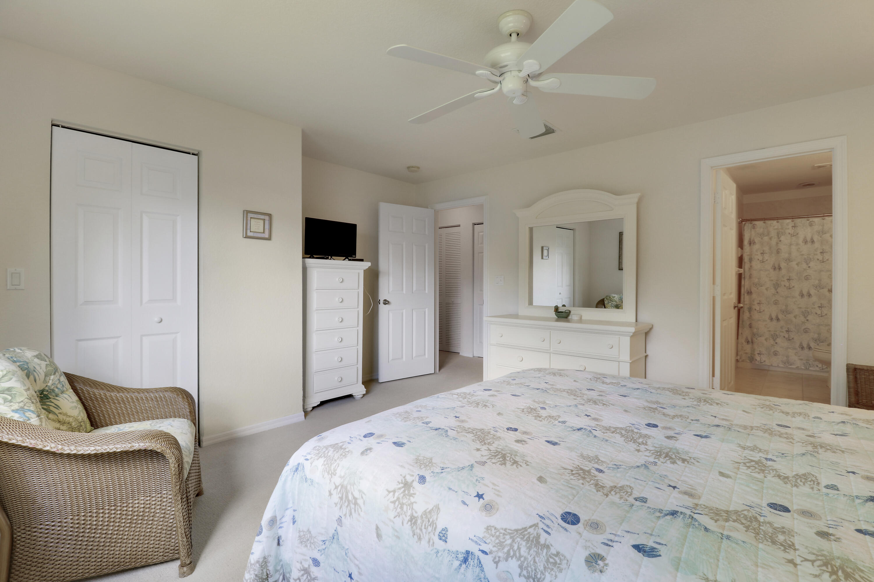 5410 Southeast Mitchell Lane Stuart, FL 34997 - Photo 15 of 24 a bedroom with a bed and a couch
