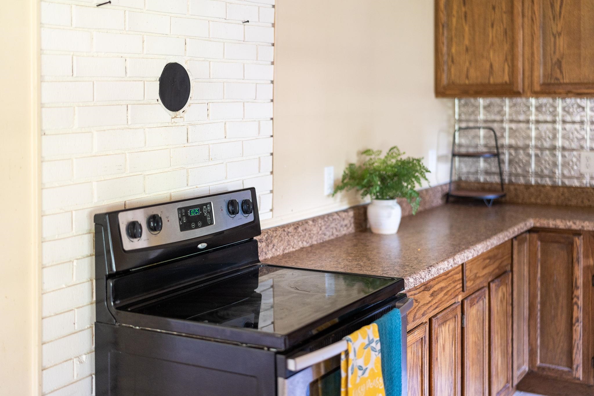 205 Devon Road Staunton, VA 24401 - Photo 28 of 71 a kitchen with a stove cabinets and potted plant