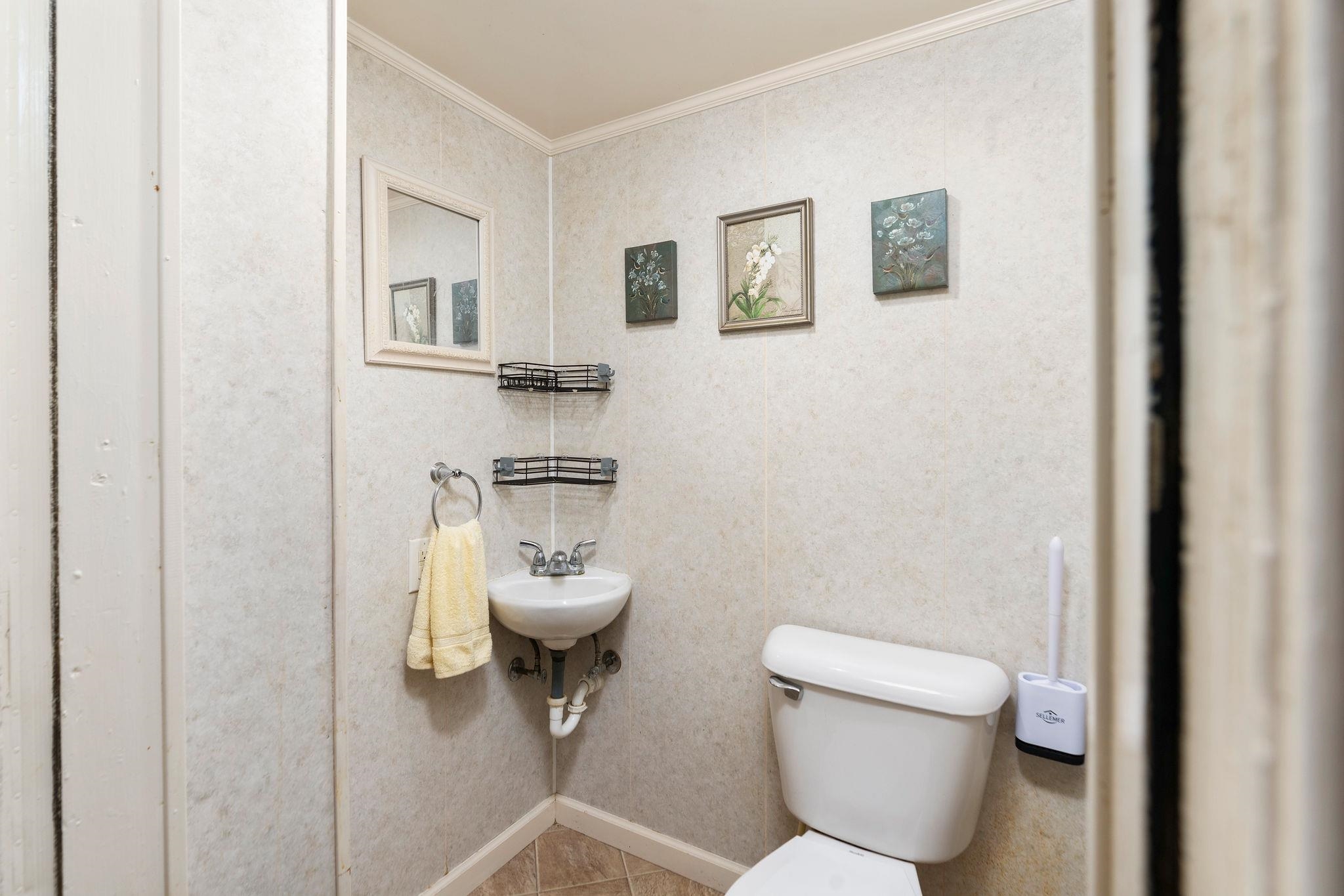 205 Devon Road Staunton, VA 24401 - Photo 33 of 71 a bathroom with a toilet sink and mirror
