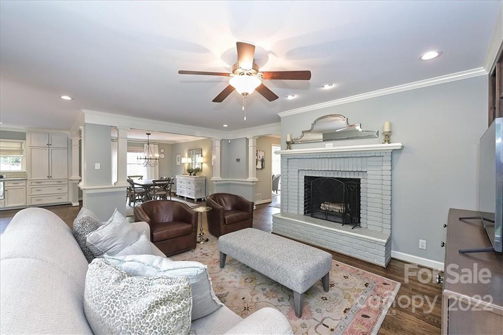 3100 Mountainbrook Road Charlotte, NC 28210 - Photo 13 of 48 a living room with furniture a fireplace and a chandelier