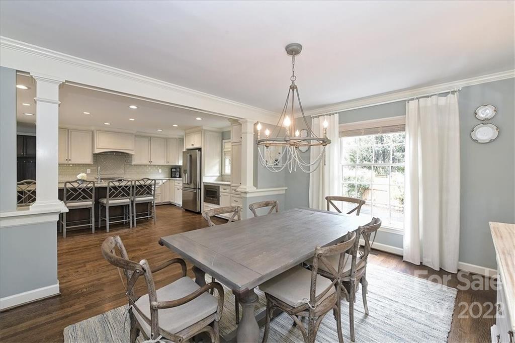 3100 Mountainbrook Road Charlotte, NC 28210 - Photo 18 of 48 a view of a dining room and livingroom with furniture wooden floor a chandelier