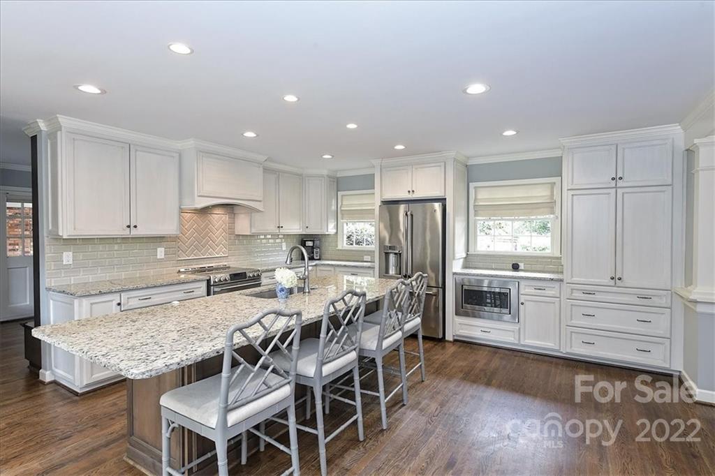 3100 Mountainbrook Road Charlotte, NC 28210 - Photo 22 of 48 a kitchen with granite countertop appliances cabinets and wooden floor